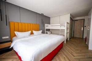 a bedroom with a large bed and bunk beds at Hotel Andante Rust in Rust +80 photos