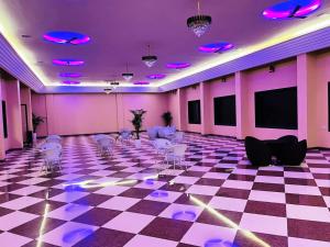 a room with a checkered floor with chairs and purple ceilings at Horizon Resort Pushkar-Feel of The Nature in Pushkar