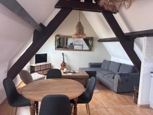 a living room with a table and a couch at Le face mer in Le Portel +23 photos