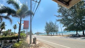 a sign on the side of a road next to the beach at Bankrut Backpack in Sathani Ban Krut