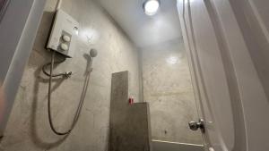 a bathroom with a shower with a shower dstg at Bankrut Backpack in Sathani Ban Krut