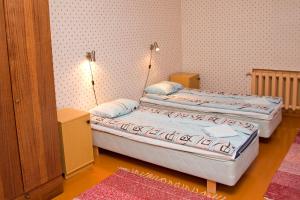 two twin beds in a room with two lamps at Student Hostel in Orissaare