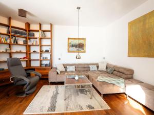 a living room with a couch and a table at Chalet Innerwald in Gnadenwald