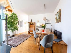 a dining room and living room with a table and chairs at Chalet Innerwald in Gnadenwald
