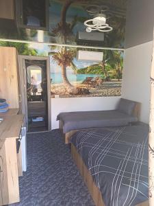 a room with a bed and a painting on the wall at Sofia Armony in Iezureni