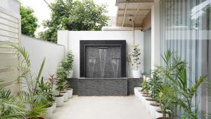 a courtyard with plants on the side of a house at Hotel Otel Besa in Nagpur