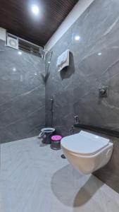 a bathroom with a toilet and a sink at Hotel Otel Besa in Nagpur +17 photos