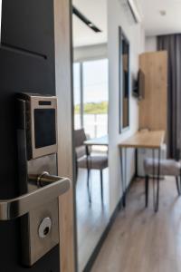 a room with a tv and a table with chairs at F&J Hotel in Sarandë