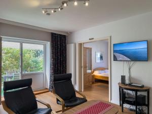 a living room with two chairs and a television at Objekt-Nr 237 - Priwall - Mecklenburger Landstraße in Priwall