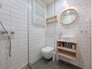 a bathroom with a toilet and a sink and a mirror at Apartmán na Špičáku in Špičák +17 photos