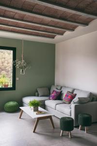 a living room with a couch and a table at Can Alemany in Santa Margarita de Mombúy