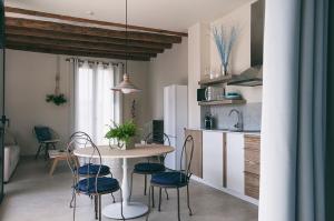 a kitchen with a table and chairs in a room at Can Alemany in Santa Margarita de Mombúy