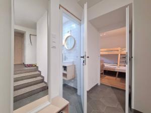 a room with a staircase and a bathroom with a sink at Apartmán na Špičáku in Špičák