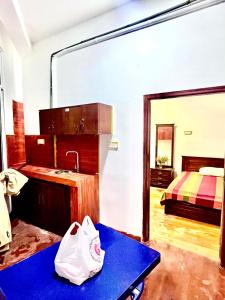 a bathroom with a sink and a bedroom with a bed at Studio Greenlands 2nd-E in Battaramulla