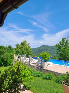 a swimming pool with a slide and a swimming yard at Koliba La Perla in Banja Luka