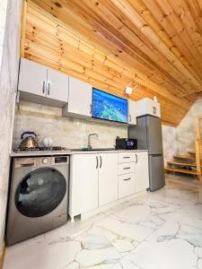 a kitchen with a stove and a dishwasher at Lerik Forest House in Lerik +4 photos