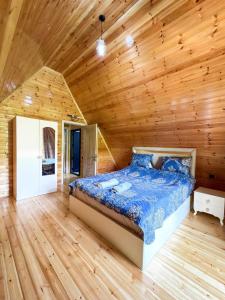 a bedroom with a bed in a wooden room at Lerik Forest House in Lerik