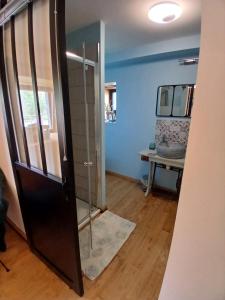a bathroom with a shower and a glass door at L étable au naturel in Mauriac +10 photos