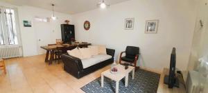 a living room with a couch and a table at Le Silodort - 7 pers - wifi - cour in Vatan