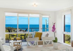 a living room with a view of the ocean at Whale Stay in Tathra