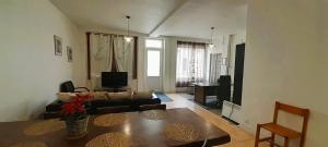 a living room with a couch and a table at Le Silodort - 7 pers - wifi - cour in Vatan
