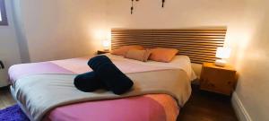a bedroom with a bed with a pair of slippers at Le Silodort - 7 pers - wifi - cour in Vatan