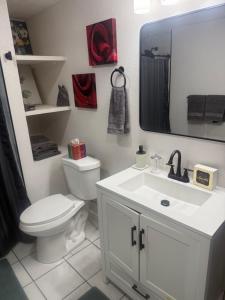 a bathroom with a toilet and a sink and a mirror at Anthony's Home in Spokane +14 photos
