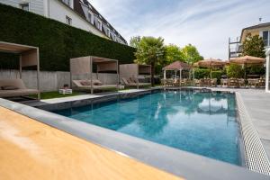 a large swimming pool in front of a building at Hotel Andante Rust in Rust