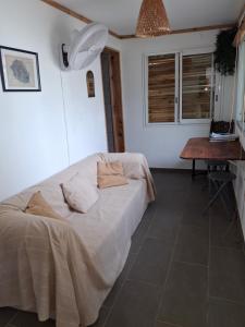 a bedroom with a bed with two pillows on it at Studio plain pied in Saint-Pierre