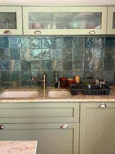 a kitchen counter with two sinks and a stove at Atelier Provençal in La Celle-sous-Gouzon +14 photos