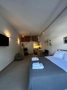 a bedroom with a bed with two towels on it at Mezzo Patmos Apartments in Patmos