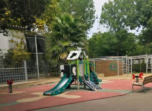 a playground with a slide in a park at camping des 7 fonts in Agde