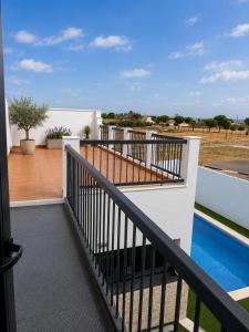 a balcony with a black railing and a swimming pool at Pozo, 22 in Fuente Palmera