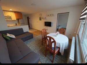 a living room with a couch and a table at Close to SCC Luxury apartment in Sarajevo in Sarajevo +17 photos