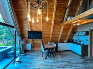 a kitchen and dining room with a wooden ceiling at Golden Horizon in Žabljak
