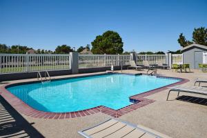 a swimming pool in a patio with a fence at Hampton Inn by Hilton Odessa in Odessa