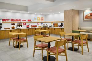 a restaurant with tables and chairs and a counter at Hampton Inn by Hilton Odessa in Odessa