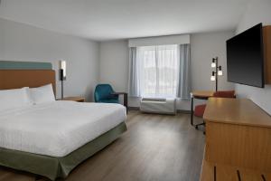 a hotel room with a bed and a desk at Hampton Inn by Hilton Odessa in Odessa +28 photos