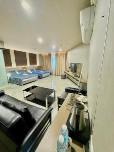 a living room with a couch and a table at Skyport Hotel in Manila
