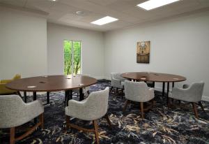 a meeting room with two tables and chairs at Hampton Inn & Suites - Vicksburg in Vicksburg