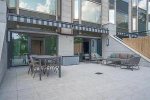 a patio with a table and chairs in front of a building at Ankara HiltonSA in Ankara