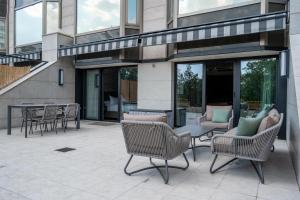 a patio with chairs and a table in front of a building at Ankara HiltonSA in Ankara +182 photos