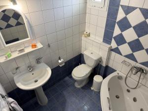 a blue and white bathroom with a sink and a toilet at Des Roses Hotel in Platanias +43 photos