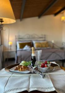 a table with a plate of food and a bowl of fruit at PIAZZADUOMO b&b Stilo in Stilo