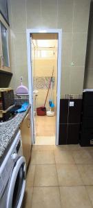 a kitchen with a door open to a room with at kabila vista vuestra a la piscina Z6 in Martil