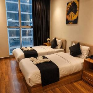 two beds in a hotel room with a window at Perlina Hotel Erbil in Erbil +41 photos