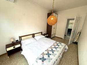 a bedroom with a bed and a pendant light at Casa Liver Pieve in Tremosine Sul Garda