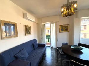 a living room with a blue couch and a table at Casa Liver Pieve in Tremosine Sul Garda