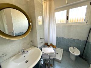 a bathroom with a sink and a mirror and a toilet at Casa Liver Pieve in Tremosine Sul Garda +27 photos