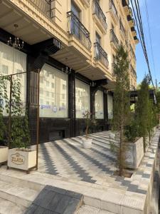 a building with a tree in front of it at Tamerlane Premium Apartment in Samarkand